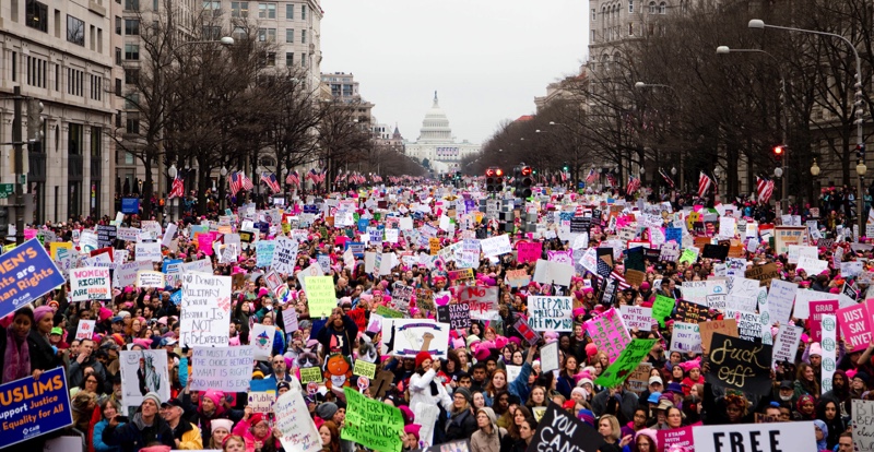 Huge crowd of people marching down Pennsylvania Avenue, Washington DC.