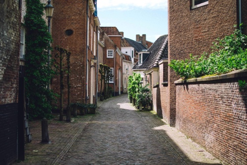 A narrow cobblestone street, possible in the low countries.